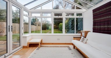A white conservatory in Basingstoke with a white sofa.